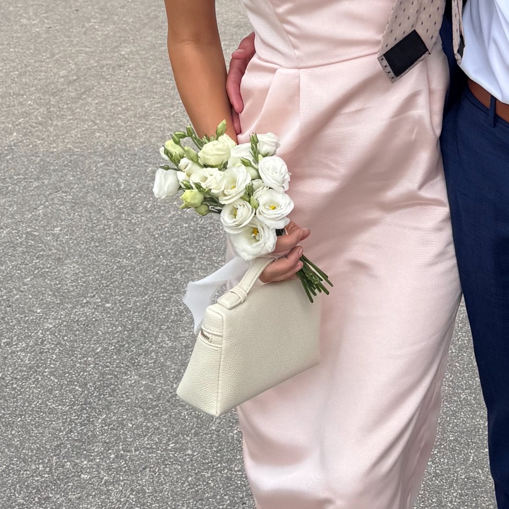 Elegant Pale Pink Satin Dress with Cream Handbag